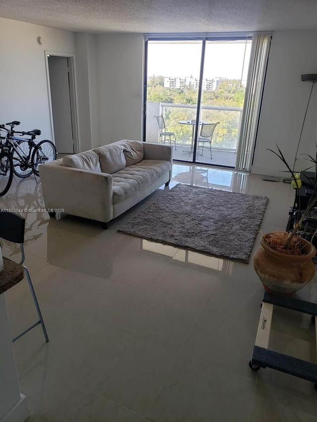 13499 Biscayne Blvd Unit 1005, North Miami, FL 33181 - living room with expansive windows, a textured ceiling, and tile patterned flooring