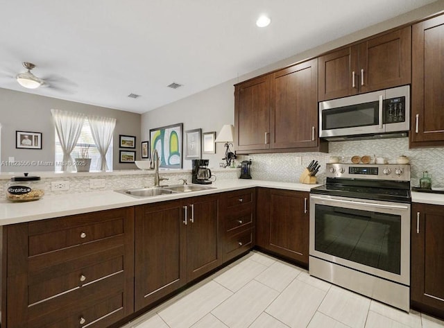 9125 SW 227th St, Cutler Bay, FL 33190 - kitchen featuring stainless steel appliances, light countertops, and backsplash