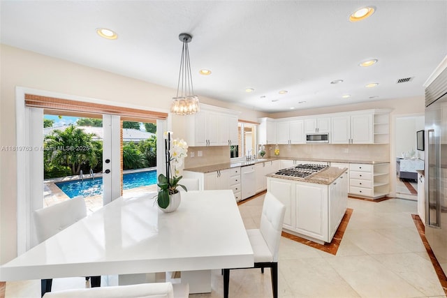 13454 SW 58th Ave, Pinecrest, FL 33156 - kitchen featuring appliances with stainless steel finishes, open shelves, a kitchen island, white cabinetry, and recessed lighting