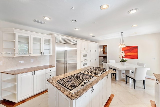 13454 SW 58th Ave, Pinecrest, FL 33156 - kitchen with appliances with stainless steel finishes, open shelves, white cabinetry, pendant lighting, and recessed lighting