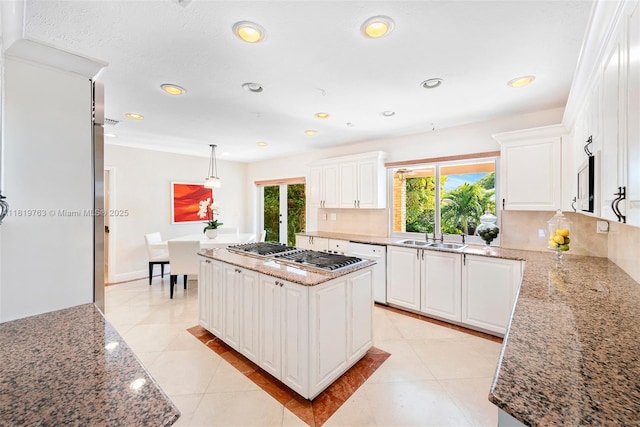 13454 SW 58th Ave, Pinecrest, FL 33156 - kitchen with stainless steel gas stovetop, white dishwasher, white cabinets, recessed lighting, and light stone counters