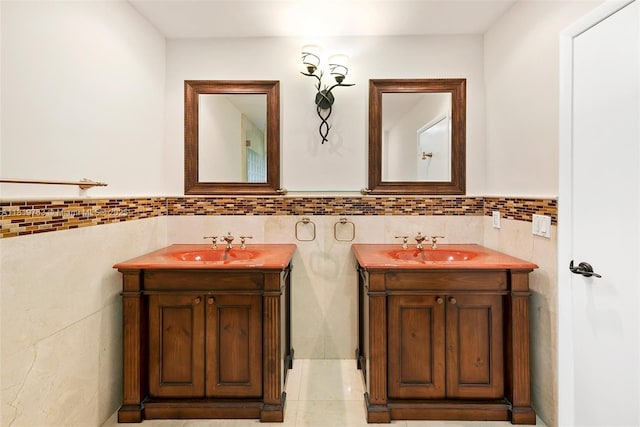 13454 SW 58th Ave, Pinecrest, FL 33156 - bathroom with tile walls, two vanities, a wainscoted wall, and tile patterned flooring