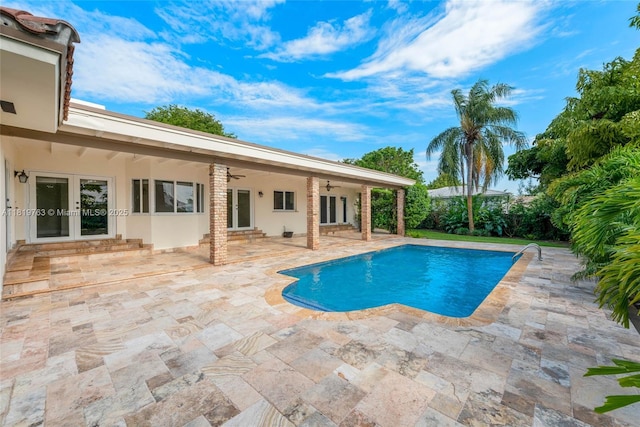13454 SW 58th Ave, Pinecrest, FL 33156 - outdoor pool with french doors, a ceiling fan, and a patio