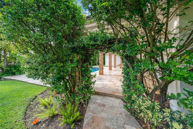 13454 SW 58th Ave, Pinecrest, FL 33156 - property entrance featuring an outdoor pool and a patio area