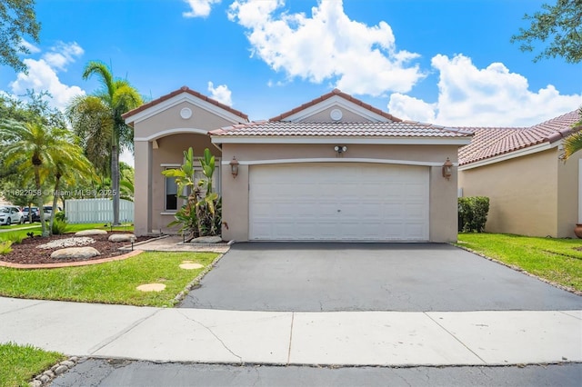 490 Talavera Rd, Weston, FL 33326 - mediterranean / spanish-style house with driveway, stucco siding, a tiled roof, and an attached garage