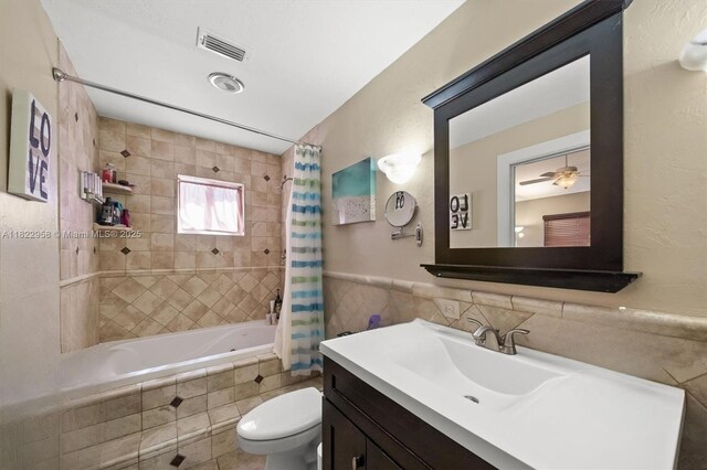 490 Talavera Rd, Weston, FL 33326 - bathroom with tile walls, tiled shower / bath, vanity, and a wainscoted wall