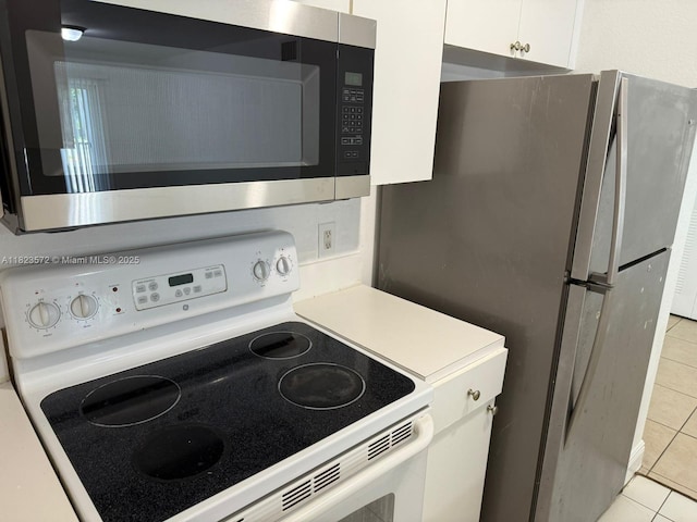 15422 SW 284th St Unit 7207, Homestead, FL 33033 - kitchen featuring appliances with stainless steel finishes, light tile patterned floors, white cabinetry, and light countertops