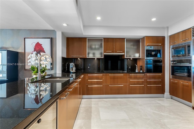 1331 Brickell Bay Dr Unit 2305, Miami, FL 33131 - kitchen featuring stainless steel appliances, modern cabinets, dark stone counters, glass insert cabinets, and recessed lighting
