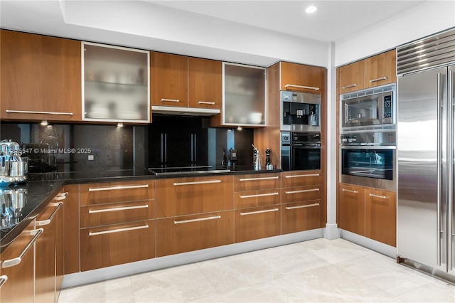 1331 Brickell Bay Dr Unit 2305, Miami, FL 33131 - kitchen with appliances with stainless steel finishes, brown cabinetry, modern cabinets, and tasteful backsplash
