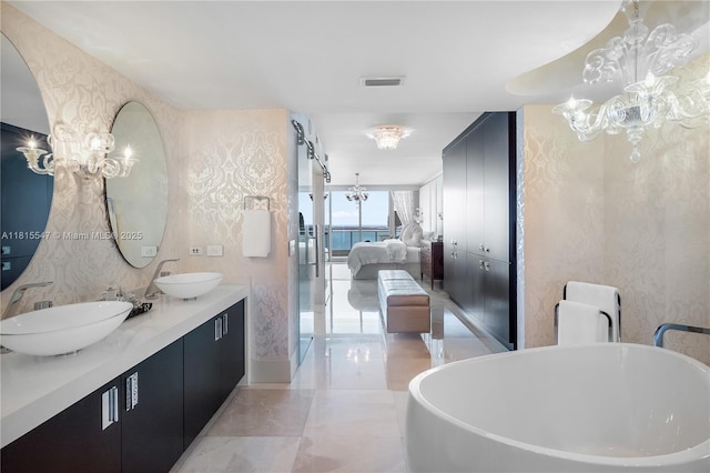 1331 Brickell Bay Dr Unit 2305, Miami, FL 33131 - ensuite bathroom featuring a chandelier, a soaking tub, and double vanity