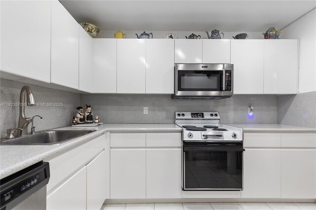 2101 S Ocean Dr Unit 2707, Hollywood, FL 33019 - kitchen featuring stainless steel appliances, light countertops, white cabinetry, and decorative backsplash