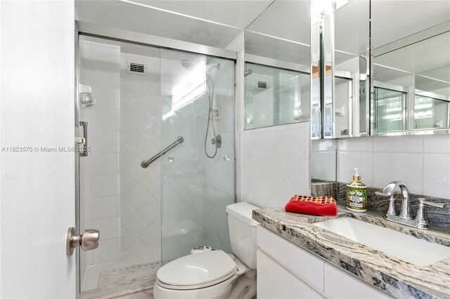 2101 S Ocean Dr Unit 2707, Hollywood, FL 33019 - bathroom featuring vanity, a stall shower, and decorative backsplash