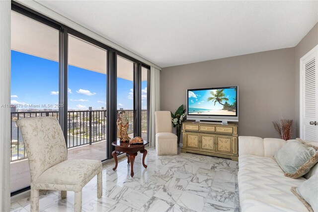 2101 S Ocean Dr Unit 2707, Hollywood, FL 33019 - living room featuring light marble finish flooring and a wall of windows