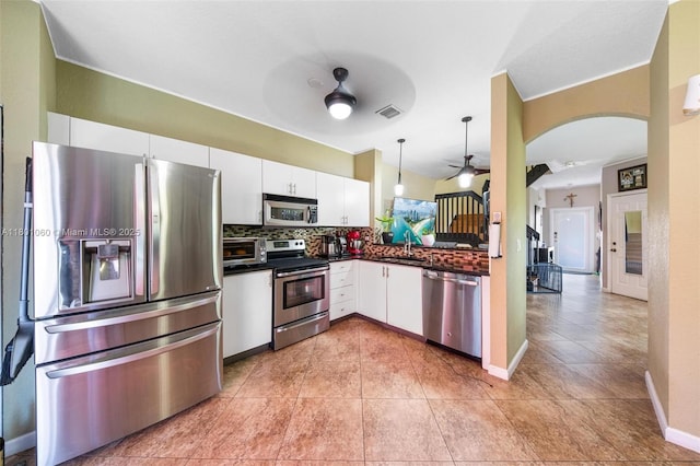 3869 NW 92nd Ave, Sunrise, FL 33351 - kitchen featuring stainless steel appliances, a ceiling fan, dark countertops, backsplash, and white cabinetry