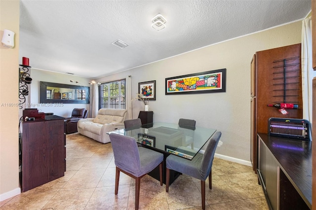 3869 NW 92nd Ave, Sunrise, FL 33351 - dining area featuring a textured ceiling and light tile patterned floors