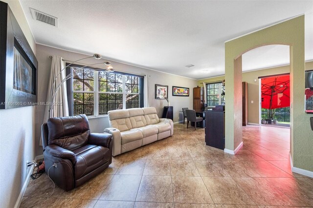 3869 NW 92nd Ave, Sunrise, FL 33351 - living room featuring arched walkways and tile patterned flooring