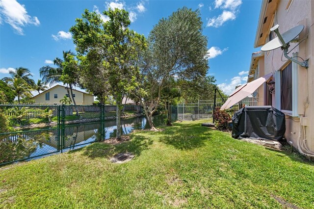3869 NW 92nd Ave, Sunrise, FL 33351 - fenced backyard featuring a water view