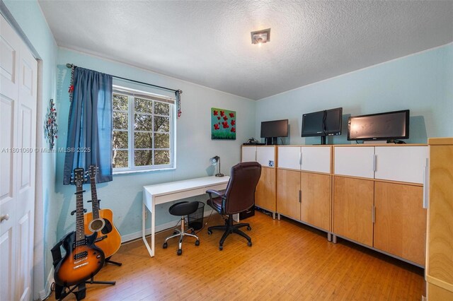 3869 NW 92nd Ave, Sunrise, FL 33351 - home office featuring light wood-type flooring and a textured ceiling