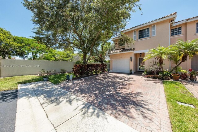 3869 NW 92nd Ave, Sunrise, FL 33351 - view of front of house with stucco siding, a garage, a tile roof, and decorative driveway