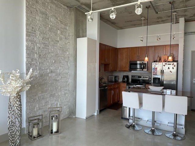 2001 Biscayne Blvd Unit 3608, Miami, FL 33137 - kitchen with appliances with stainless steel finishes, dark countertops, a towering ceiling, tasteful backsplash, and finished concrete flooring