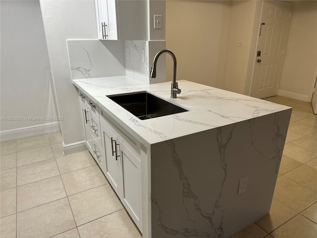 15221 SW 80th St Unit 304, Miami, FL 33193 - kitchen featuring light tile patterned flooring, light stone counters, and white cabinets