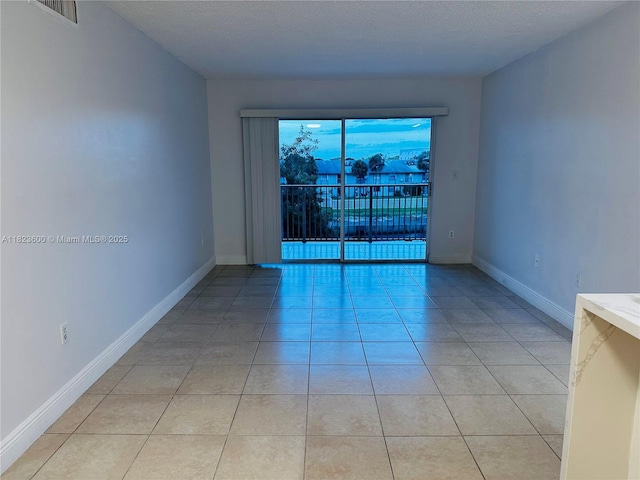 15221 SW 80th St Unit 304, Miami, FL 33193 - empty room with light tile patterned flooring and a textured ceiling