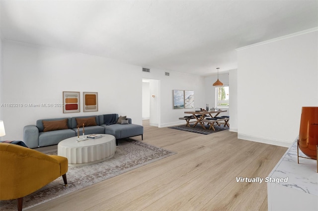 7635 SW 57th Ave Unit 2, South Miami, FL 33143 - living room featuring light wood-style floors and crown molding