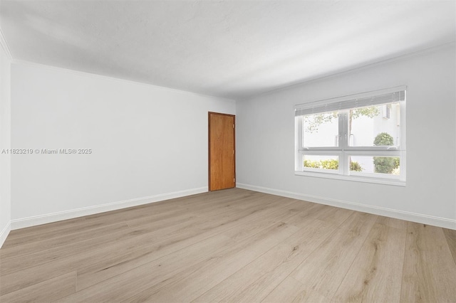 7635 SW 57th Ave Unit 2, South Miami, FL 33143 - spare room featuring light wood-style flooring and ornamental molding
