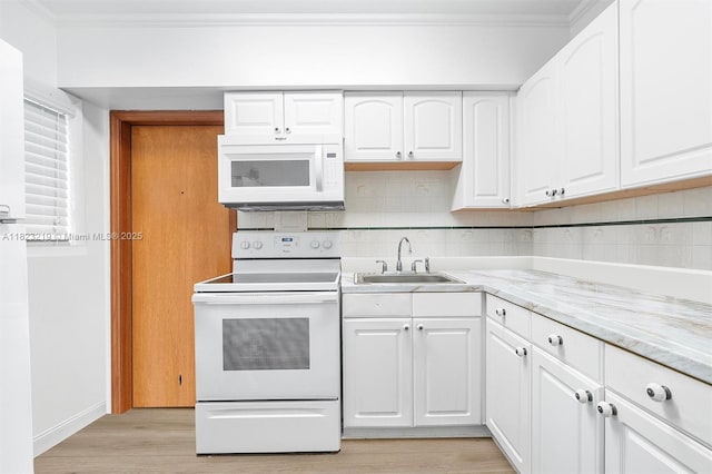 7635 SW 57th Ave Unit 2, South Miami, FL 33143 - kitchen with white appliances, light wood-type flooring, ornamental molding, backsplash, and white cabinets