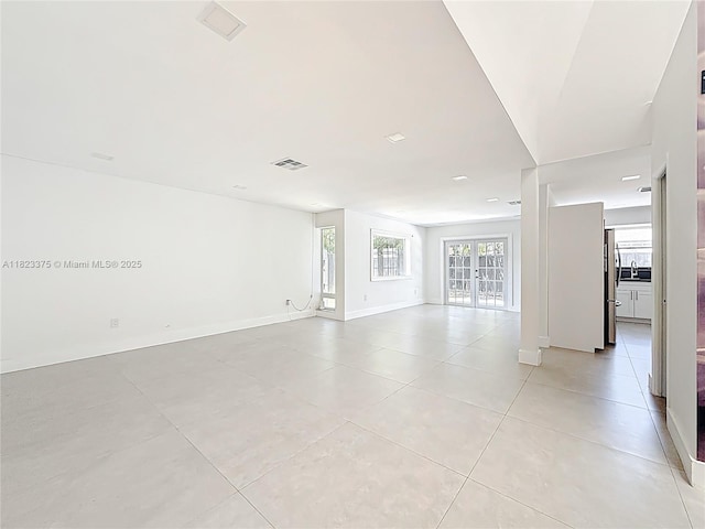 4996 SW 95th Ave, Cooper City, FL 33328 - unfurnished living room with light tile patterned floors and baseboards