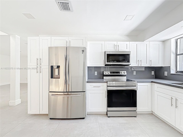 4996 SW 95th Ave, Cooper City, FL 33328 - kitchen featuring stainless steel appliances, light tile patterned floors, and white cabinets