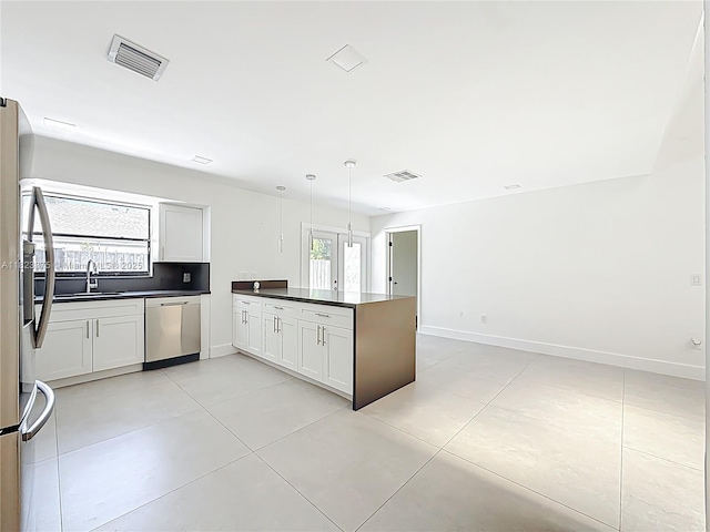 4996 SW 95th Ave, Cooper City, FL 33328 - kitchen with appliances with stainless steel finishes, a peninsula, dark countertops, and light tile patterned flooring
