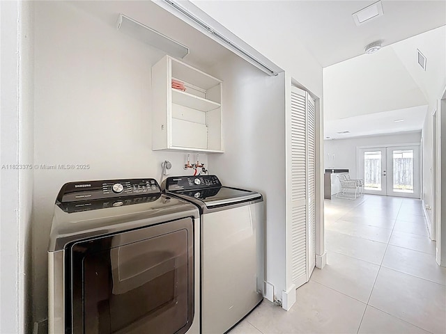 4996 SW 95th Ave, Cooper City, FL 33328 - laundry room with washer and dryer, light tile patterned floors, and french doors
