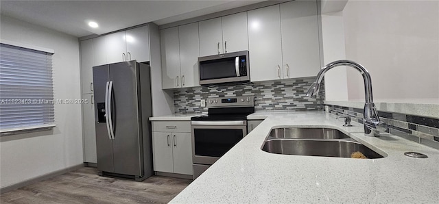 100 SW 130th Ter Unit 309C, Pembroke Pines, FL 33027 - kitchen featuring appliances with stainless steel finishes, light wood finished floors, tasteful backsplash, recessed lighting, and gray cabinets
