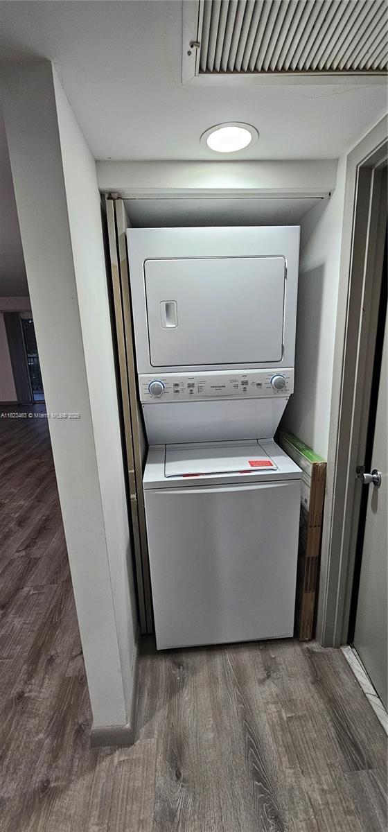 100 SW 130th Ter Unit 309C, Pembroke Pines, FL 33027 - washroom featuring stacked washer / drying machine and wood finished floors