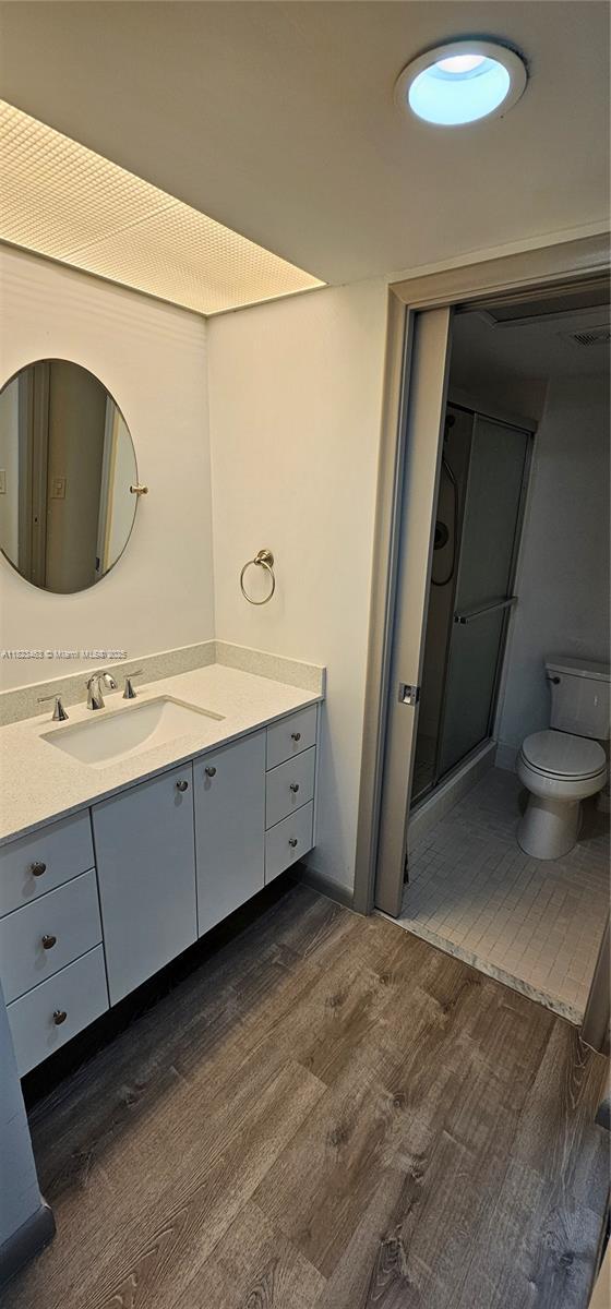 100 SW 130th Ter Unit 309C, Pembroke Pines, FL 33027 - bathroom featuring wood finished floors, vanity, and a stall shower