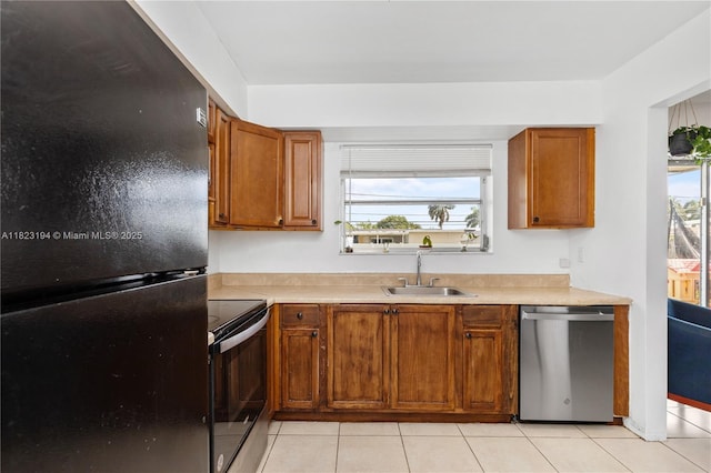 8851 NW 12th St, Pembroke Pines, FL 33024 - kitchen with appliances with stainless steel finishes, brown cabinets, light countertops, light tile patterned flooring, and healthy amount of natural light