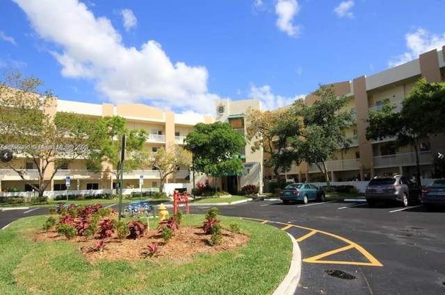 9587 Weldon Cir Unit B203, Tamarac, FL 33321 - view of property featuring uncovered parking