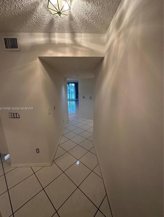 9587 Weldon Cir Unit B203, Tamarac, FL 33321 - corridor with light tile patterned floors and a textured ceiling