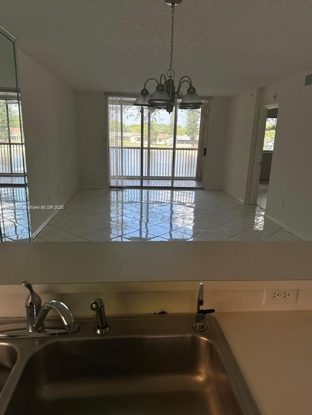9587 Weldon Cir Unit B203, Tamarac, FL 33321 - unfurnished dining area with a chandelier and light tile patterned floors
