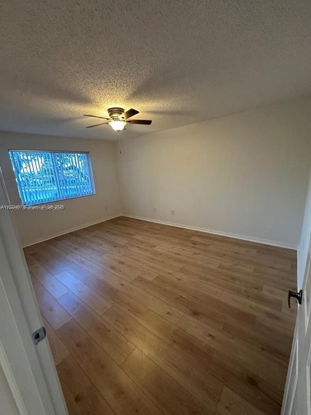 9587 Weldon Cir Unit B203, Tamarac, FL 33321 - empty room featuring a ceiling fan, wood finished floors, and a textured ceiling
