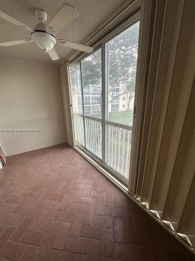 9587 Weldon Cir Unit B203, Tamarac, FL 33321 - spare room featuring brick patterned floors and a ceiling fan