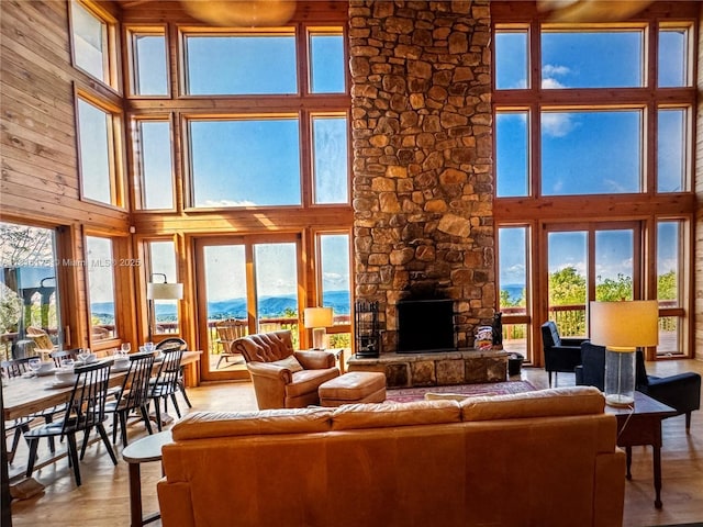 200 Summit Lodge Rd, Nc, NC 28604 - living area with a towering ceiling, healthy amount of natural light, a fireplace, light wood-style floors, and wood walls