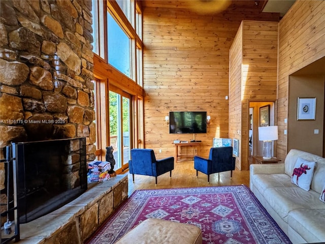 200 Summit Lodge Rd, Nc, NC 28604 - living room with a towering ceiling, wooden walls, wood finished floors, and a stone fireplace