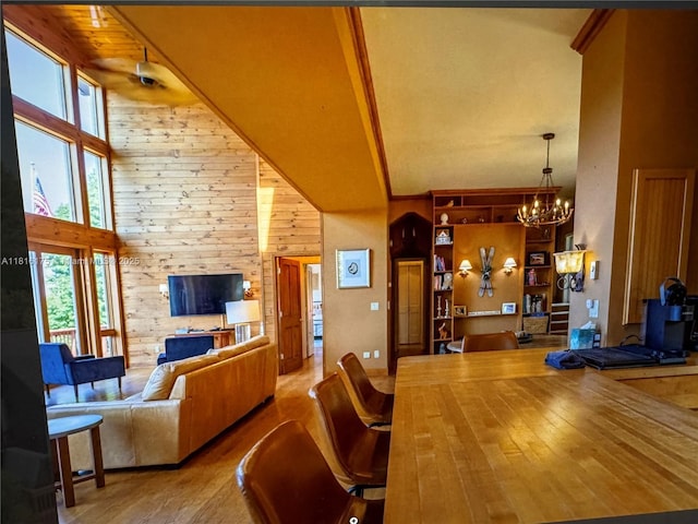 200 Summit Lodge Rd, Nc, NC 28604 - dining room featuring high vaulted ceiling, a chandelier, healthy amount of natural light, wood finished floors, and wood walls