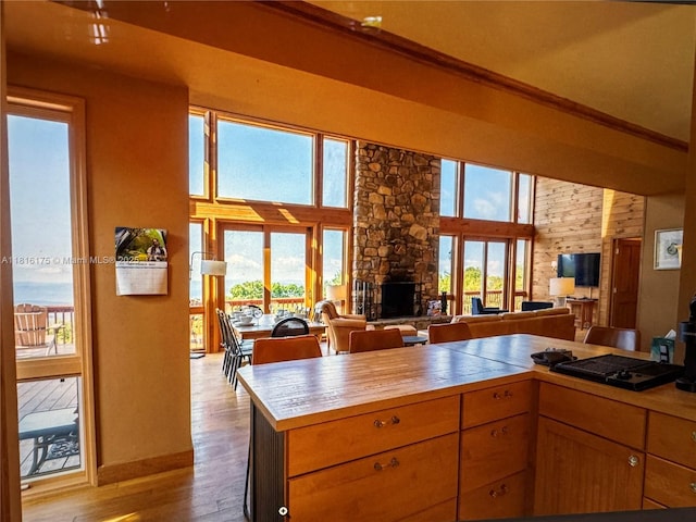 200 Summit Lodge Rd, Nc, NC 28604 - kitchen with a fireplace, wood finished floors, a towering ceiling, ornamental molding, and open floor plan