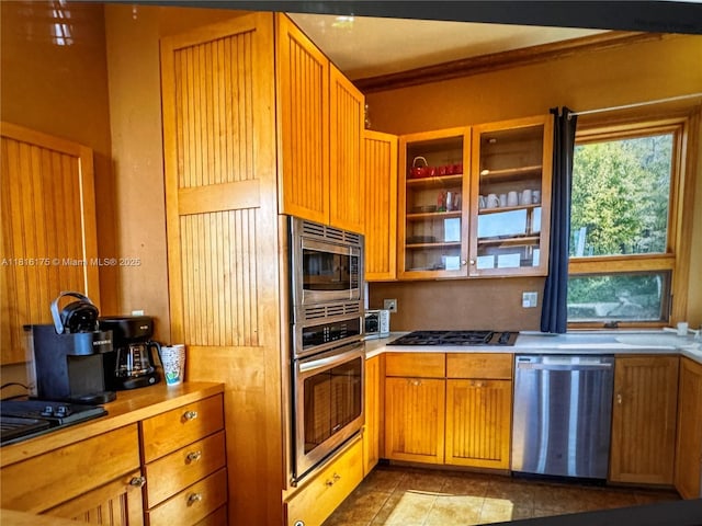 200 Summit Lodge Rd, Nc, NC 28604 - kitchen featuring stainless steel appliances, light countertops, tile patterned floors, glass insert cabinets, and brown cabinets