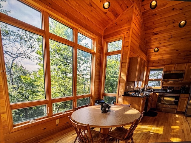 200 Summit Lodge Rd, Nc, NC 28604 - dining room with lofted ceiling, wood walls, plenty of natural light, and hardwood / wood-style floors