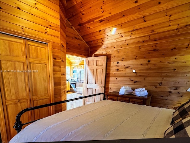 200 Summit Lodge Rd, Nc, NC 28604 - bedroom featuring lofted ceiling, wood walls, stainless steel fridge, wood ceiling, and a closet