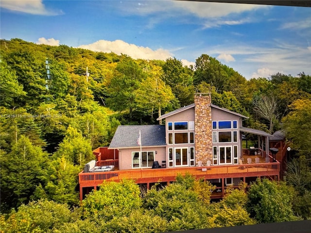200 Summit Lodge Rd, Nc, NC 28604 - back of house featuring a view of trees, a wooden deck, and a chimney